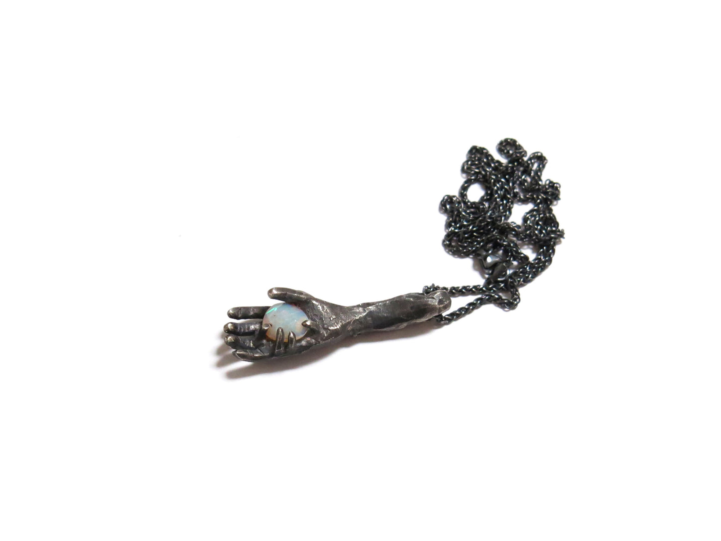 HAND HOLDING FACETED OPAL