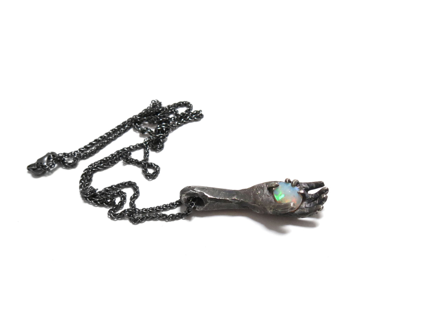 HAND HOLDING FACETED OPAL