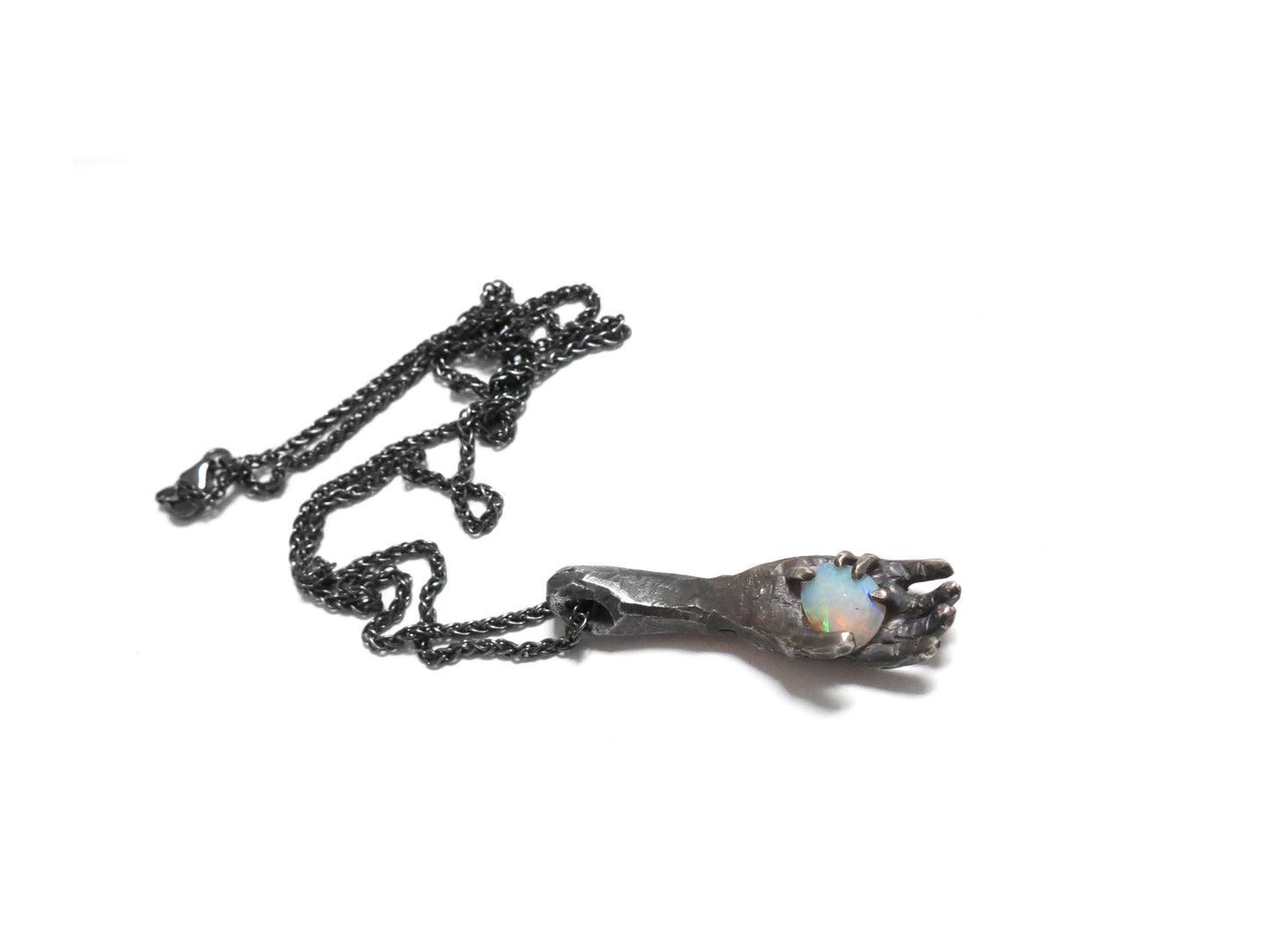 HAND HOLDING FACETED OPAL