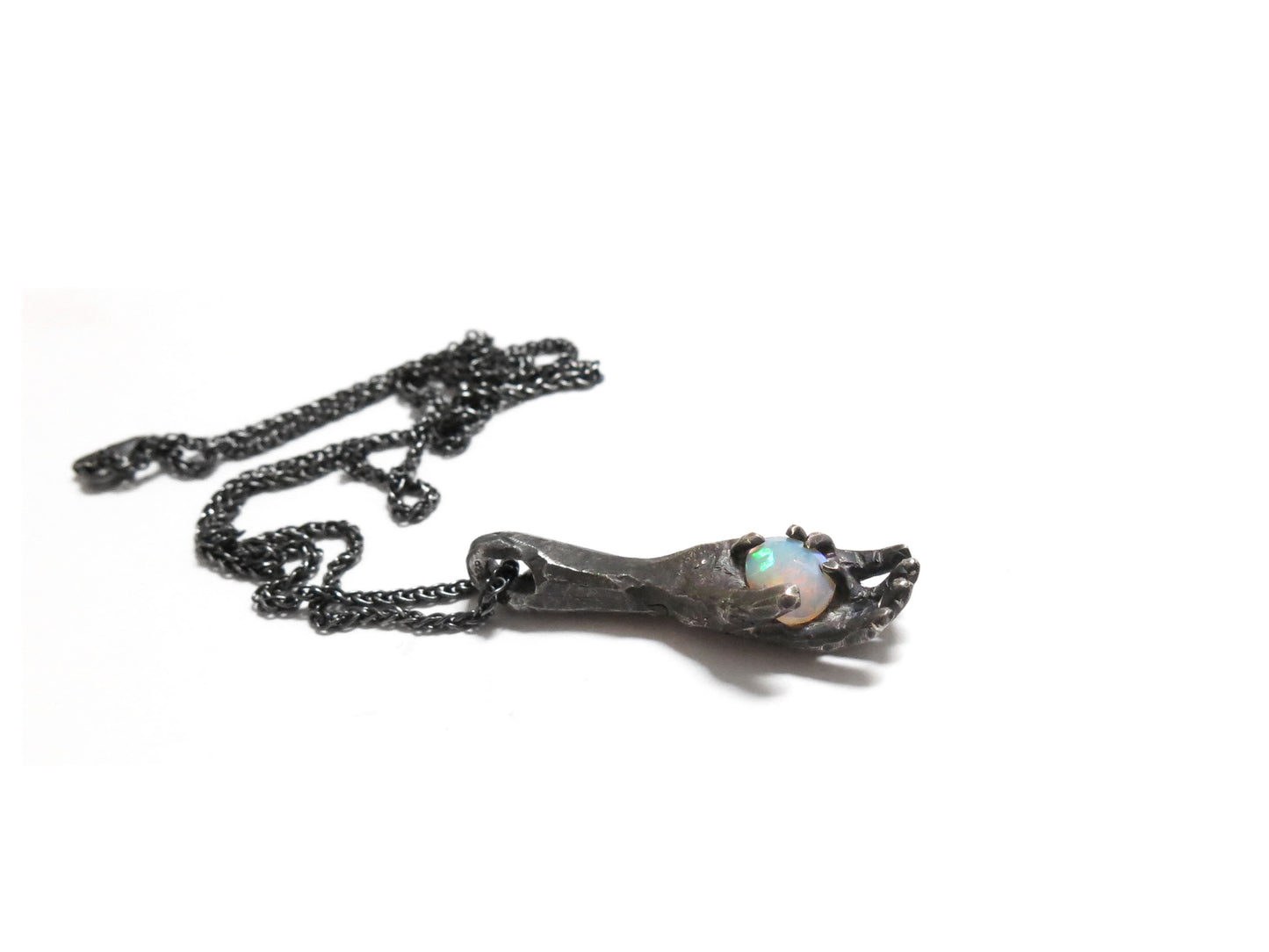 HAND HOLDING FACETED OPAL