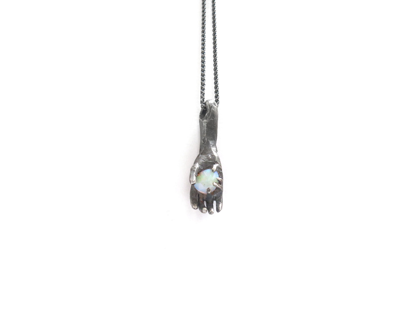 HAND HOLDING FACETED OPAL