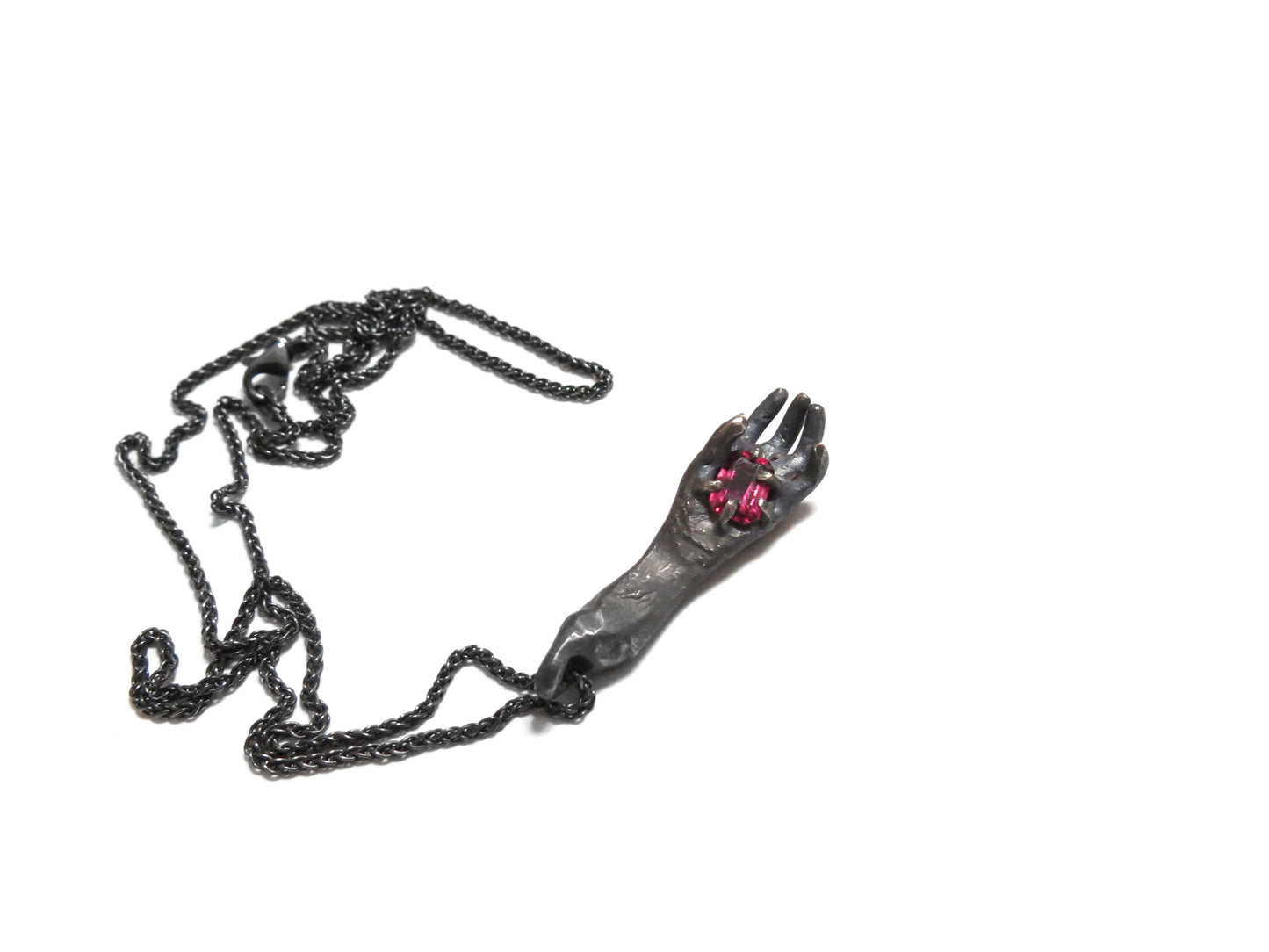 HAND HOLDING RHODOLITE GARNET
