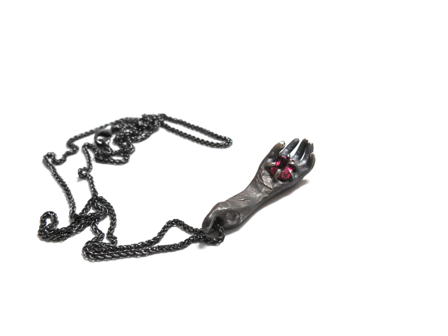 HAND HOLDING RHODOLITE GARNET