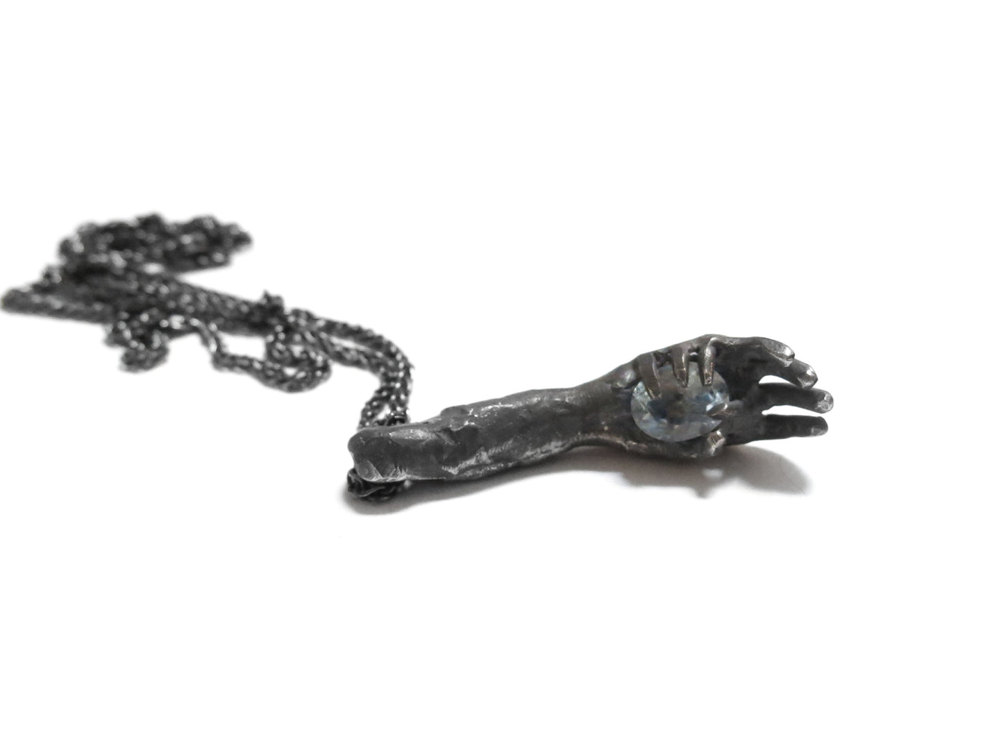 HAND HOLDING SKY BLUE TOPAZ