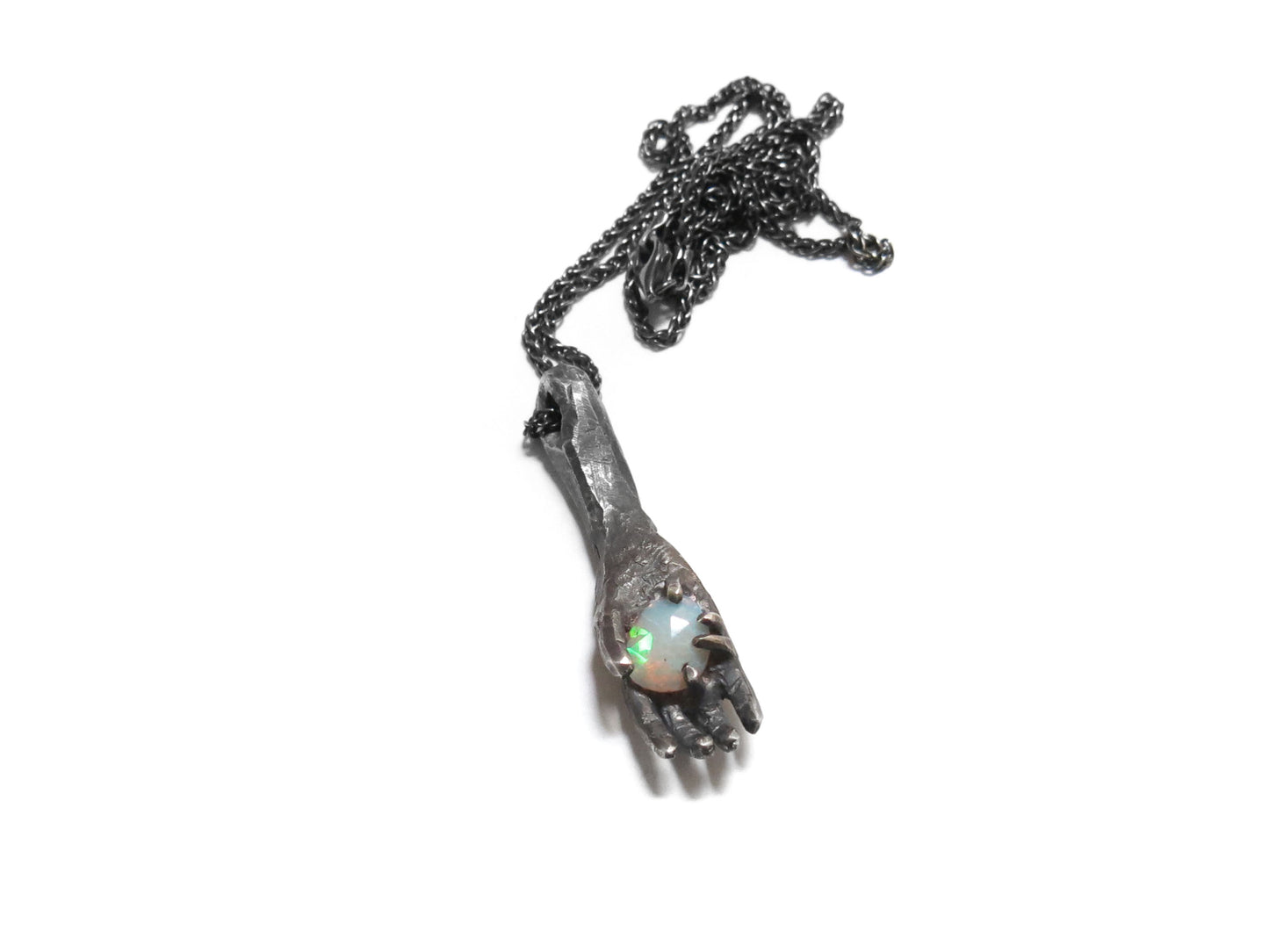 HAND HOLDING FACETED OPAL