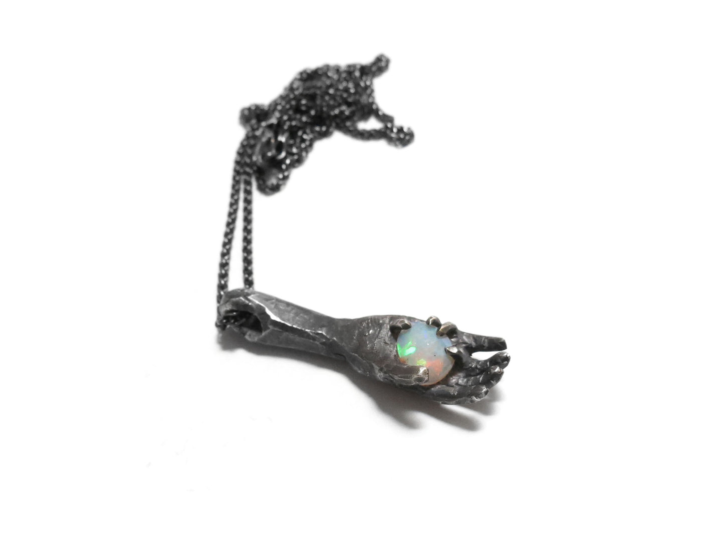 HAND HOLDING FACETED OPAL