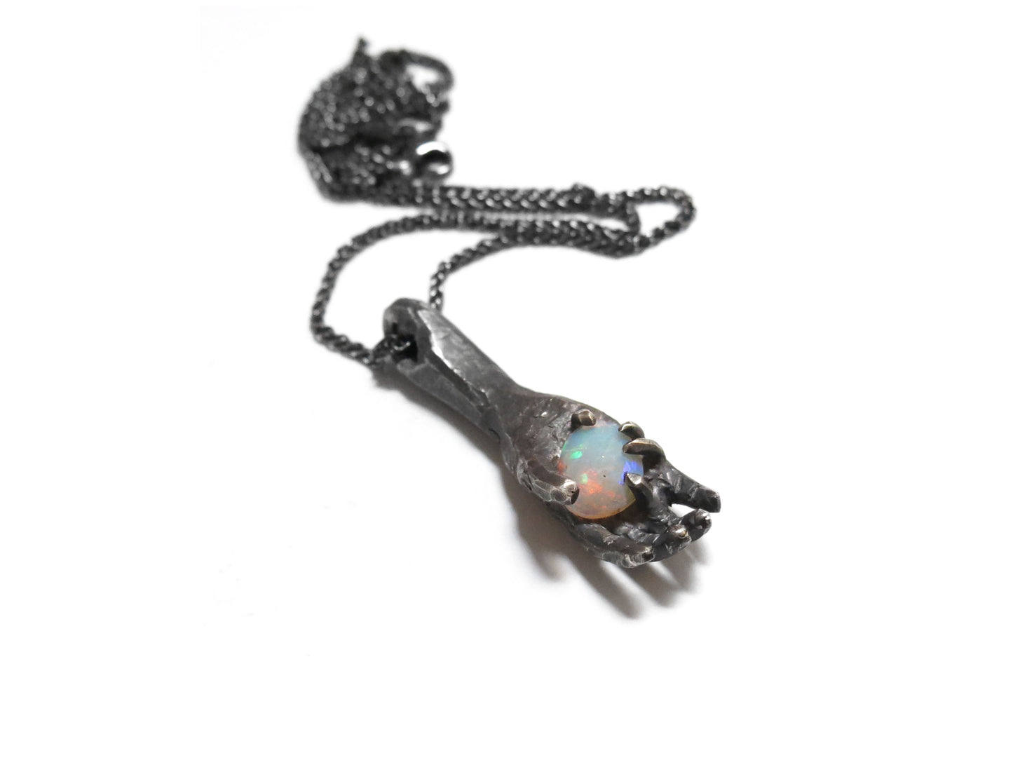 HAND HOLDING FACETED OPAL
