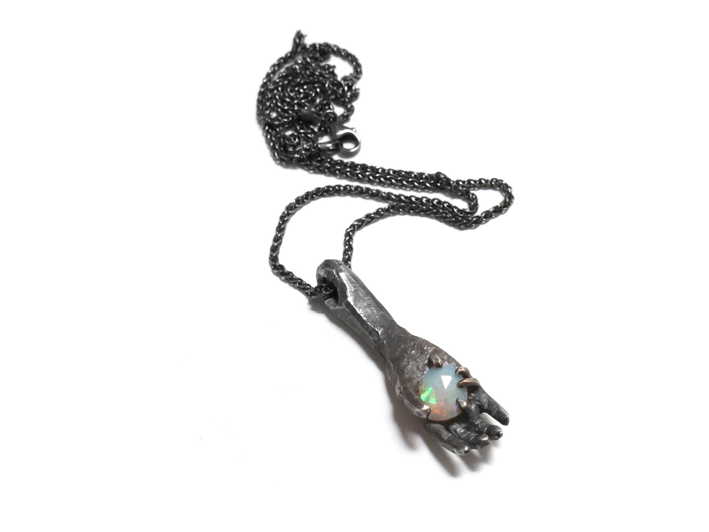 HAND HOLDING FACETED OPAL