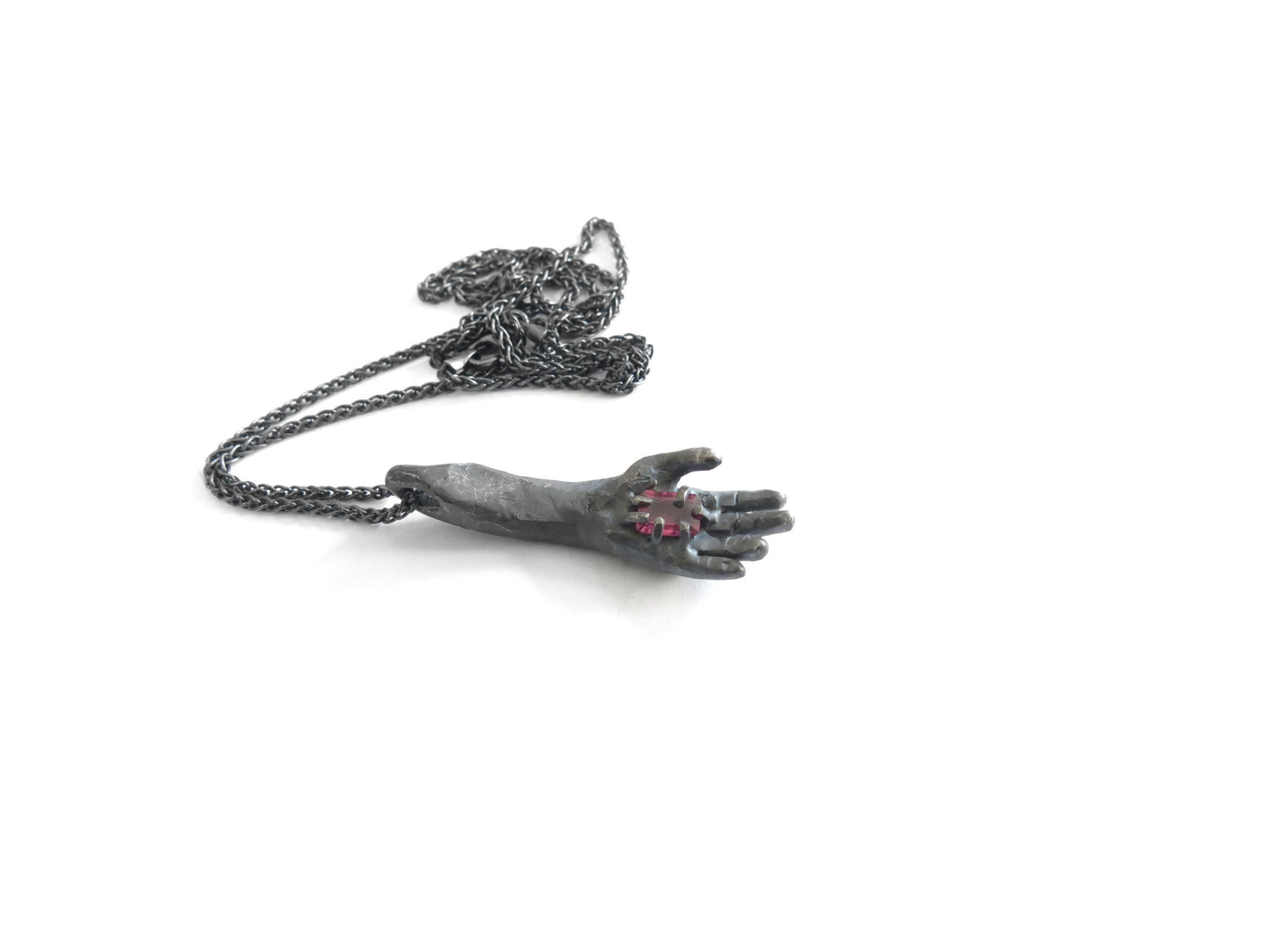 HAND HOLDING RECTANGULAR RHODOLITE GARNET