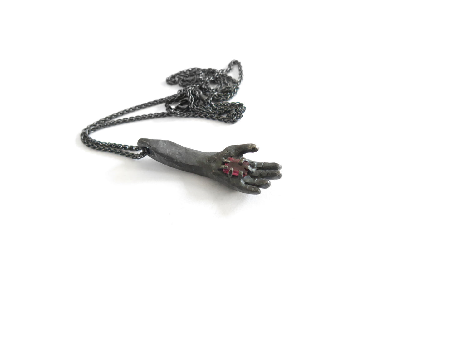 HAND HOLDING RECTANGULAR RHODOLITE GARNET