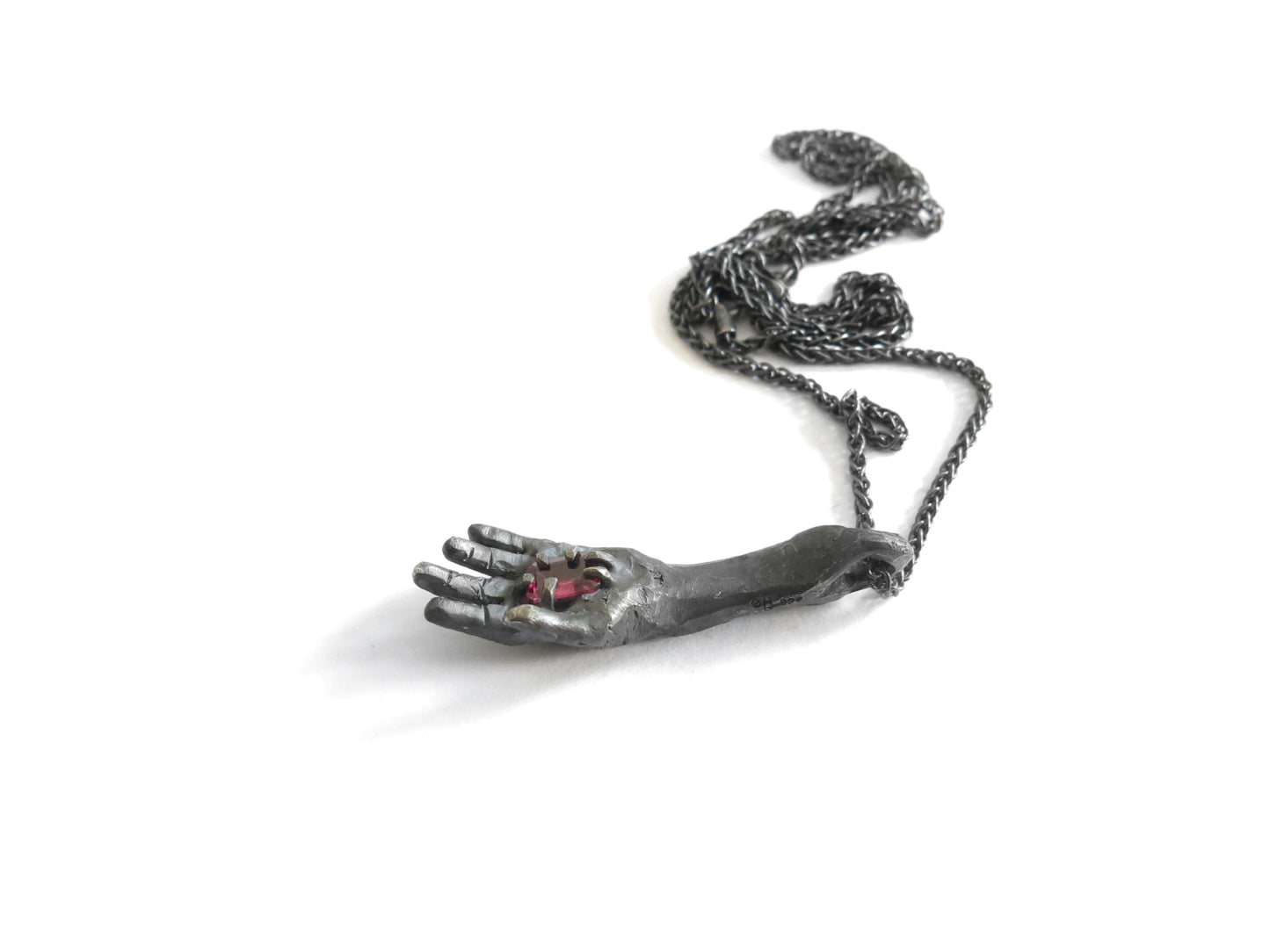 HAND HOLDING RECTANGULAR RHODOLITE GARNET