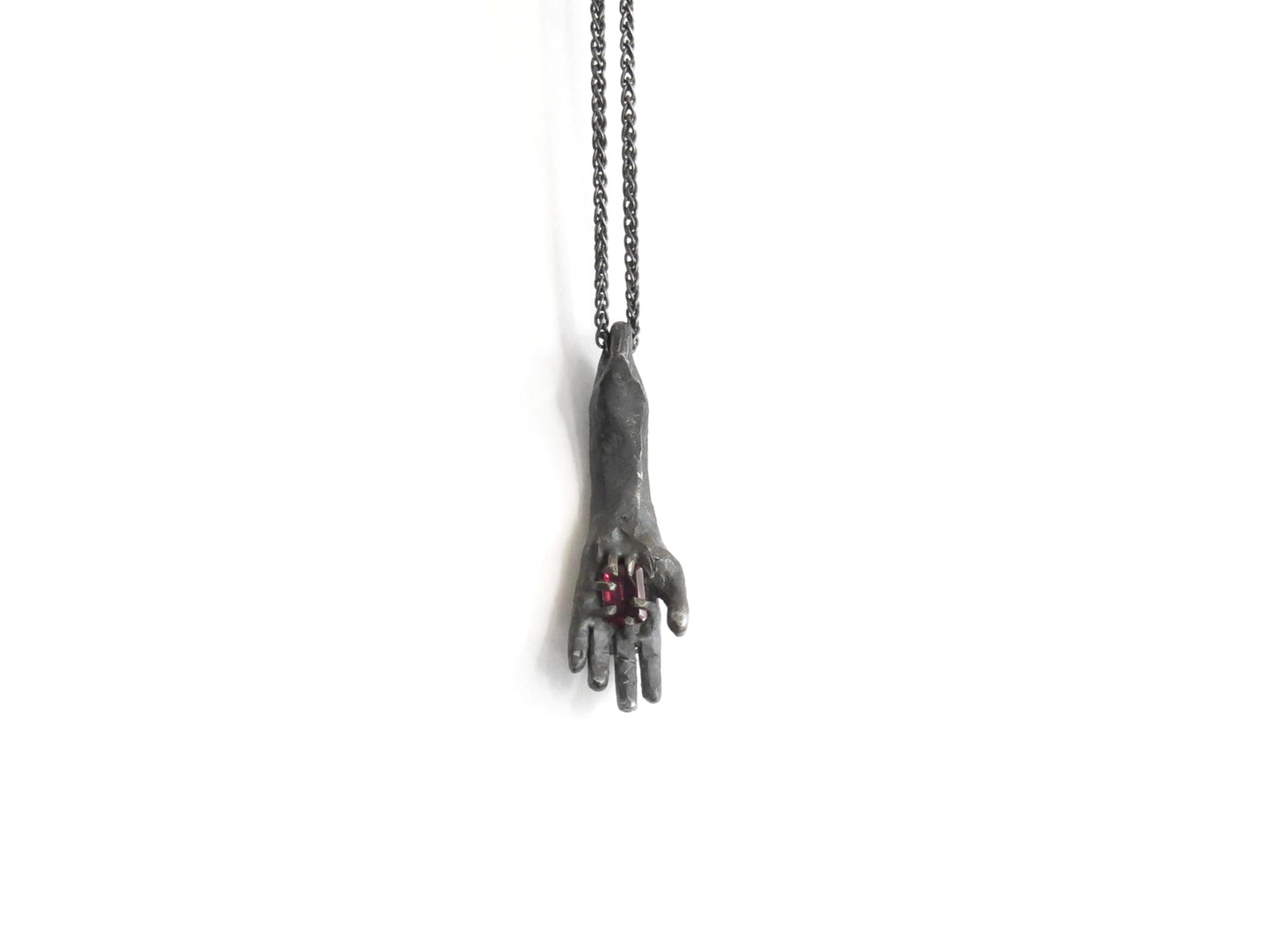 HAND HOLDING RECTANGULAR RHODOLITE GARNET