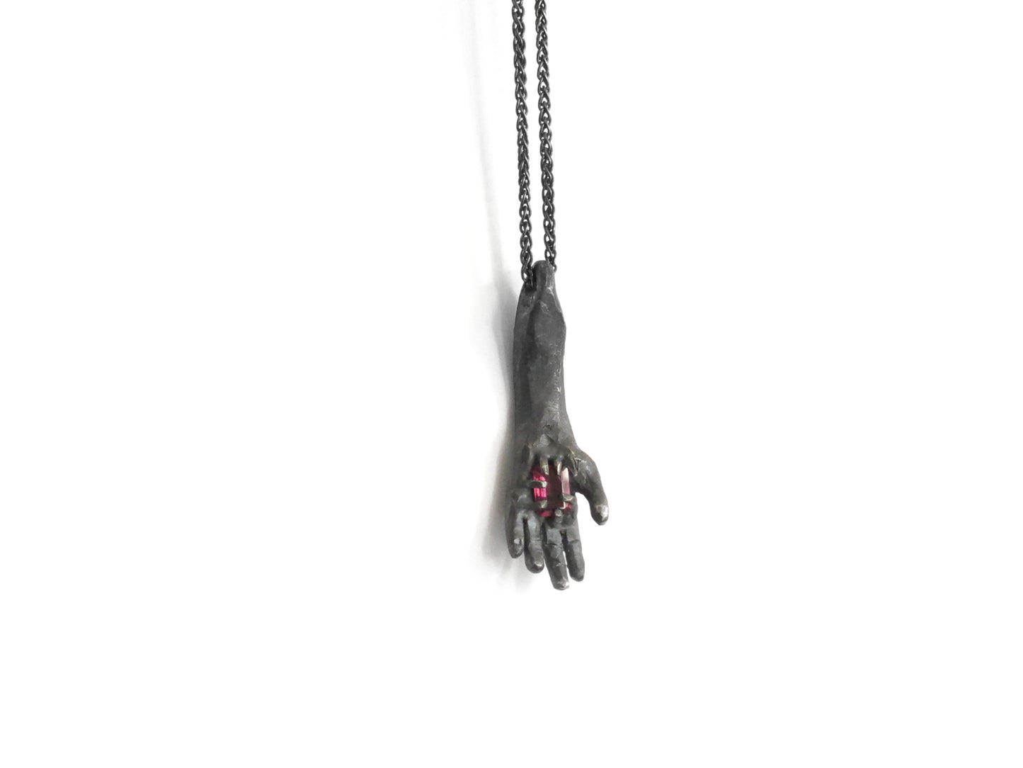 HAND HOLDING RECTANGULAR RHODOLITE GARNET