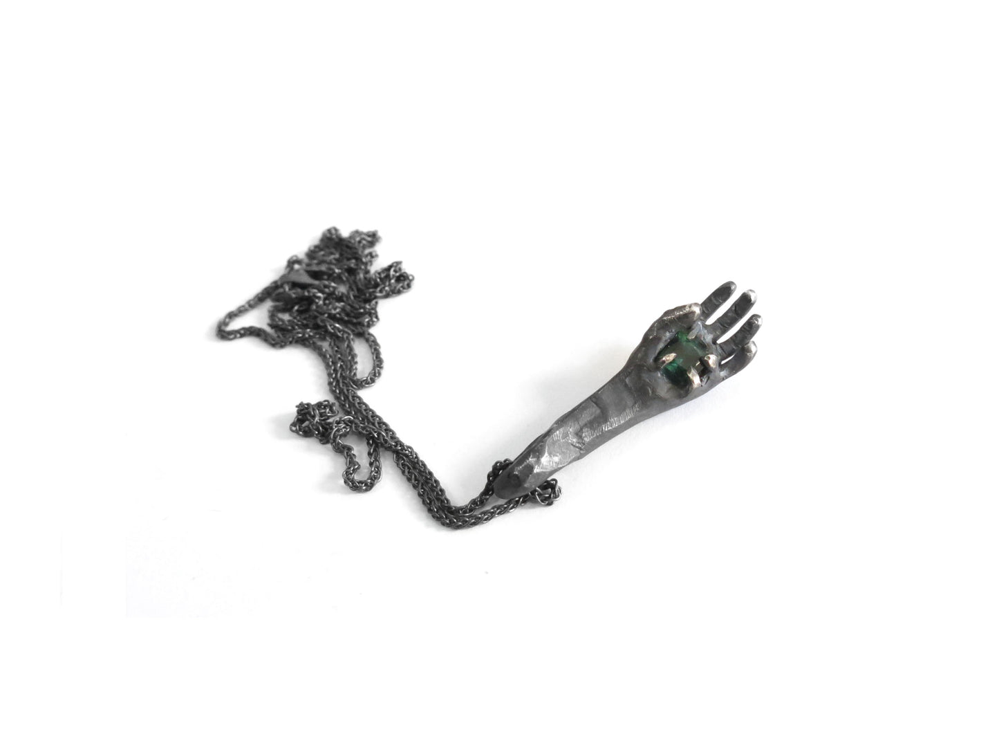 HAND HOLDING DARK GREEN TOURMALINE