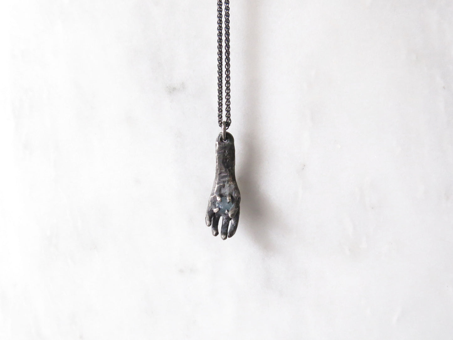 HAND HOLDING ROUGH MONTANA SAPPHIRE