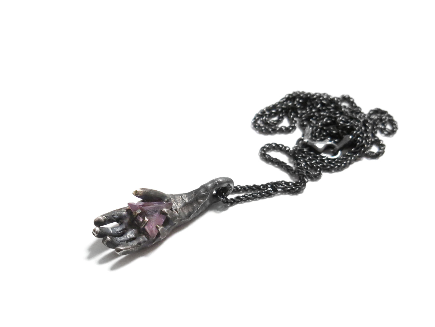 HAND HOLDING TRIANGLE AMETHYST
