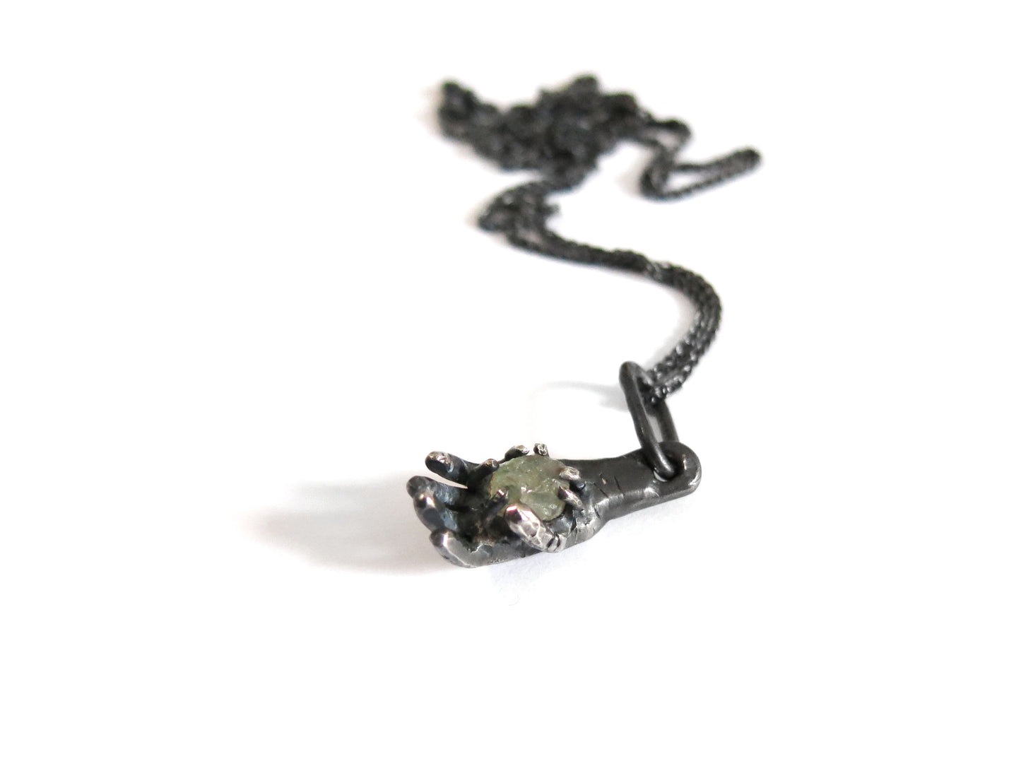 HAND HOLDING ROUGH SAPPHIRE