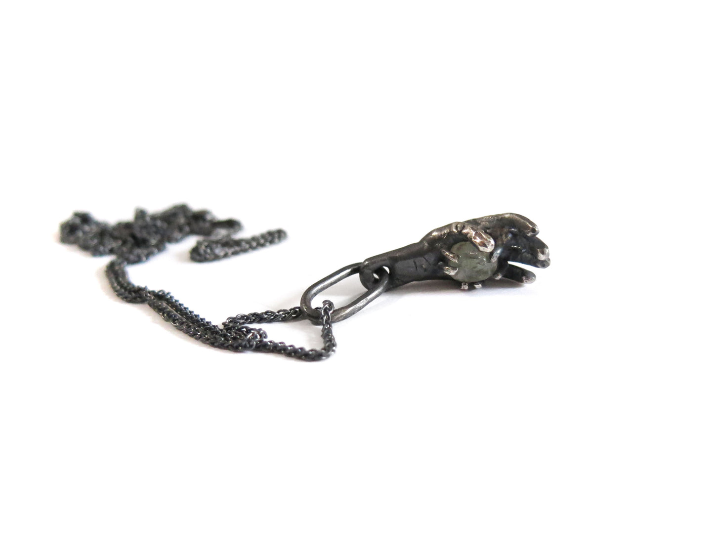 HAND HOLDING ROUGH SAPPHIRE