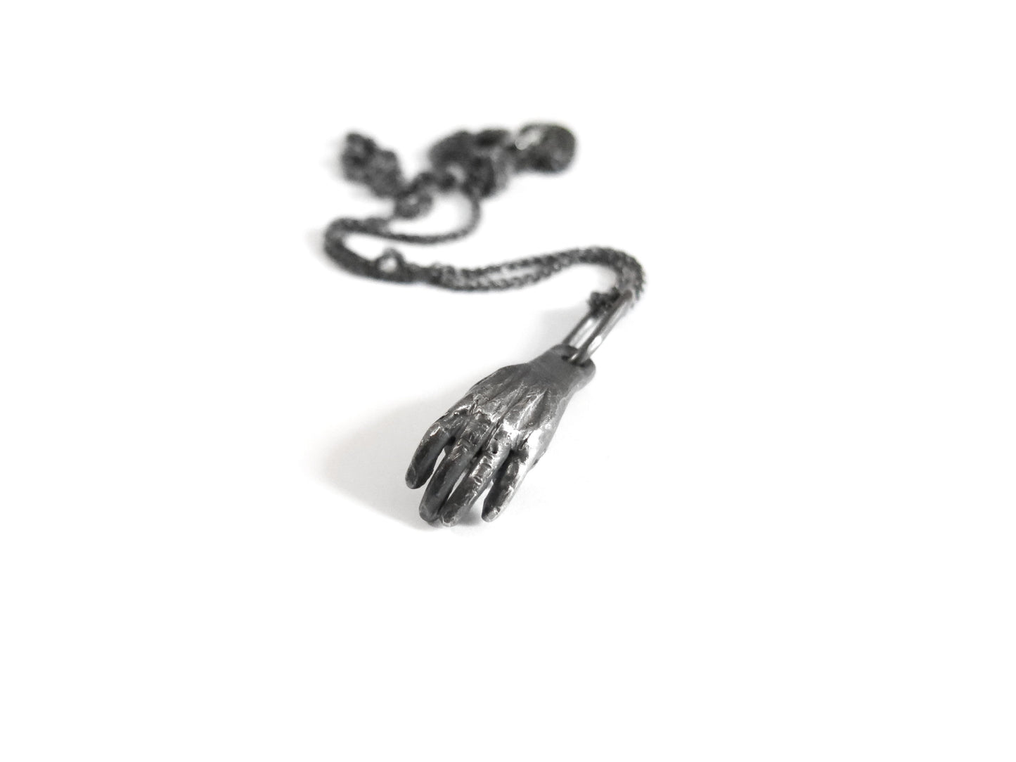 HAND HOLDING ROUGH DIAMOND