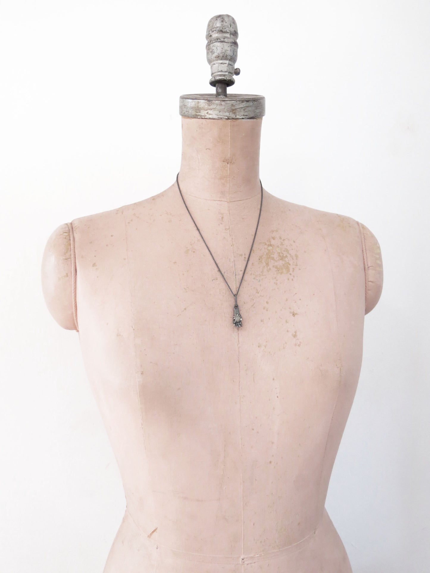 HAND HOLDING ROUGH SAPPHIRE