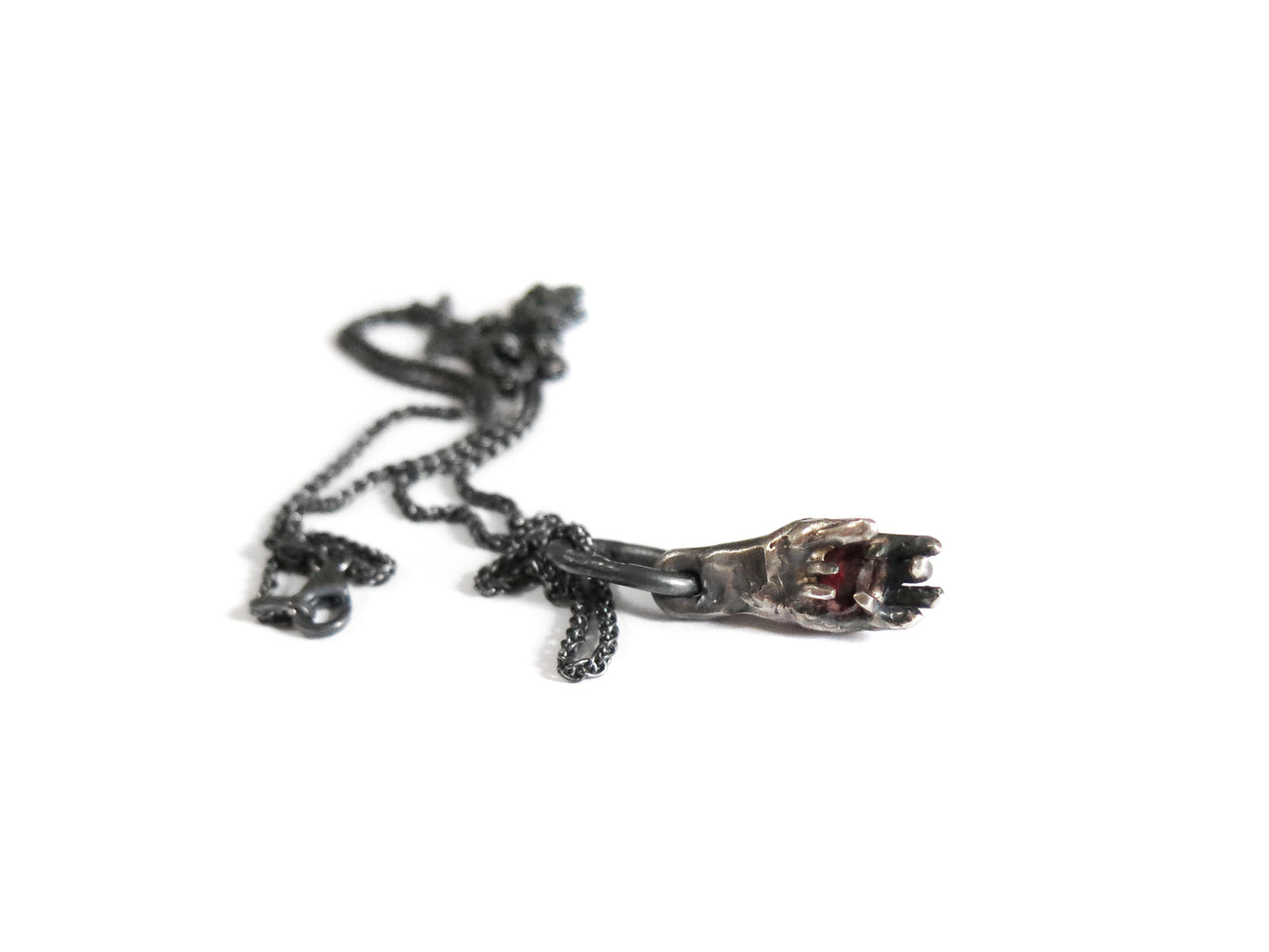 HAND HOLDING RHODOLITE GARNET