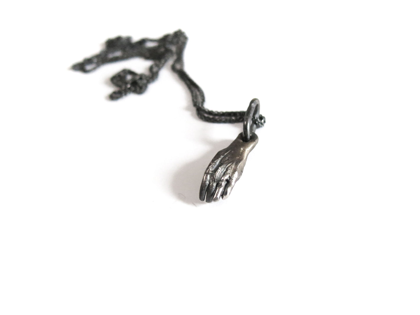HAND HOLDING RHODOLITE GARNET