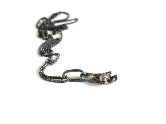 HAND HOLDING ROUGH DIAMOND