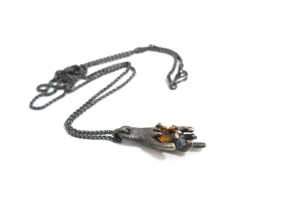 HAND HOLDING CITRINE