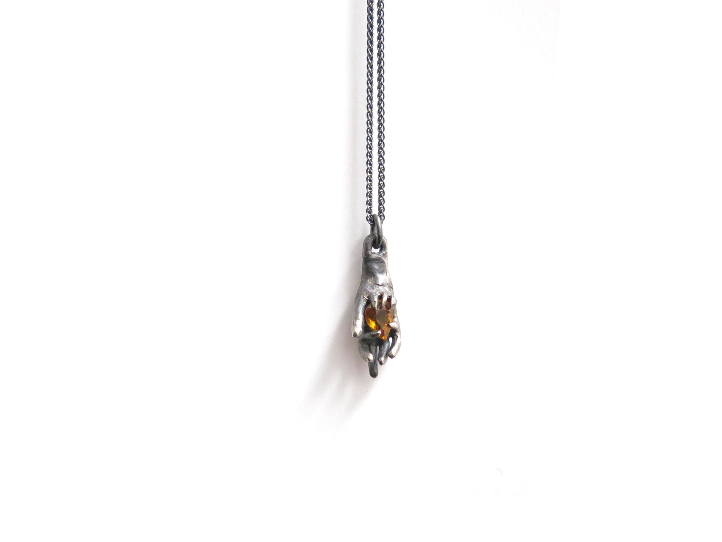 HAND HOLDING CITRINE