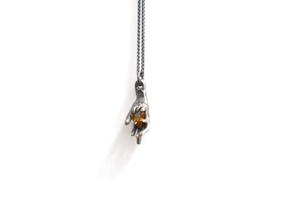 HAND HOLDING CITRINE