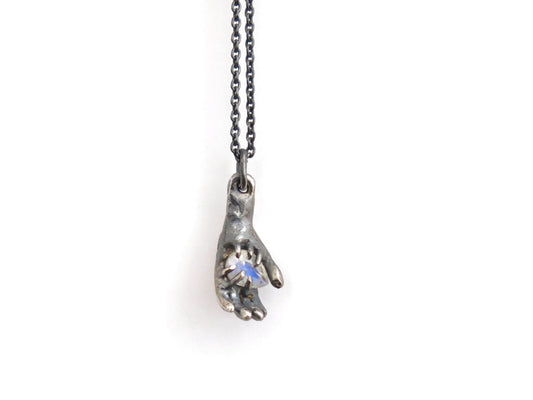 HAND HOLDING RAINBOW MOONSTONE