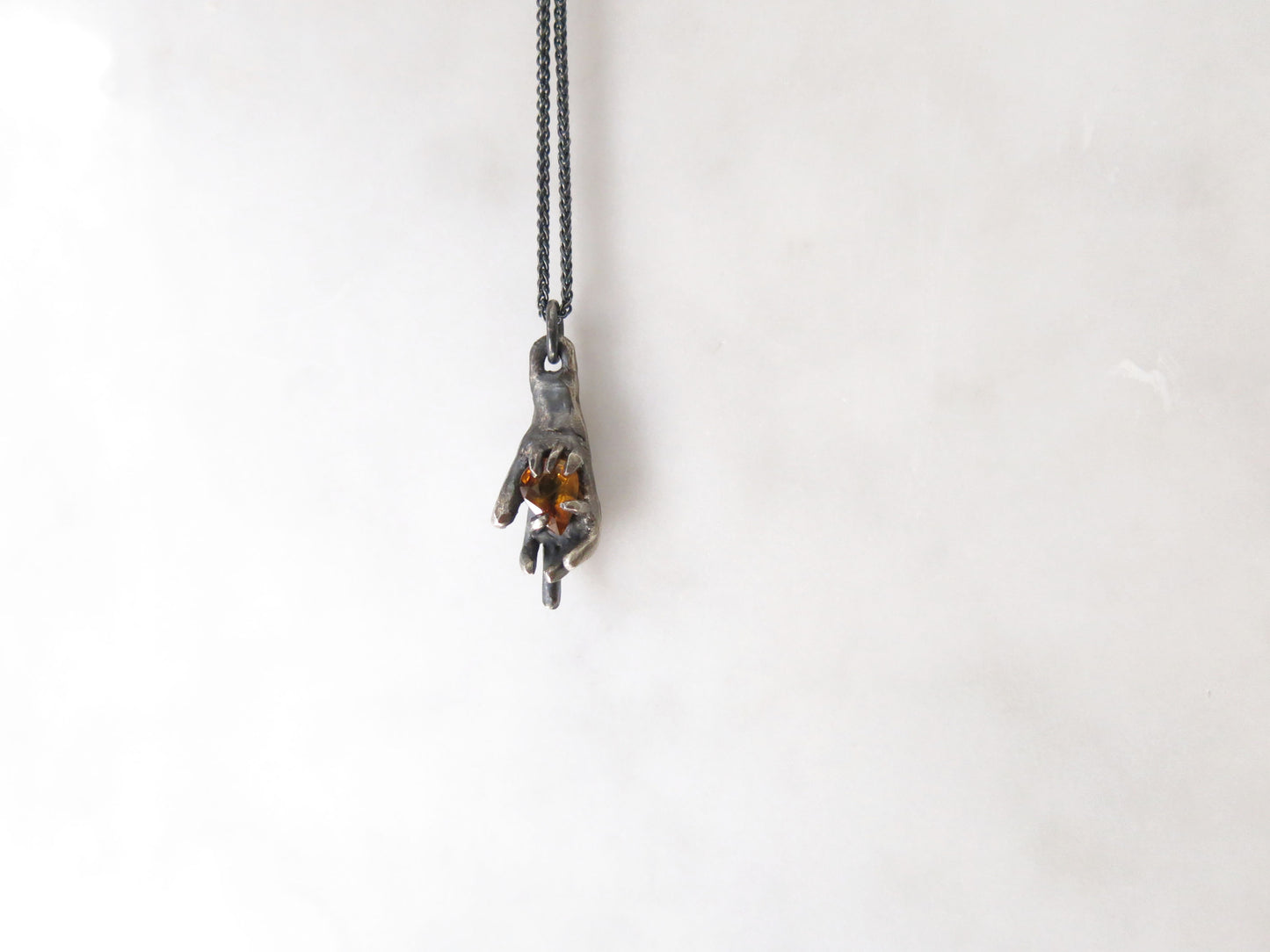 HAND HOLDING CITRINE