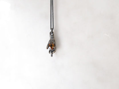 HAND HOLDING CITRINE